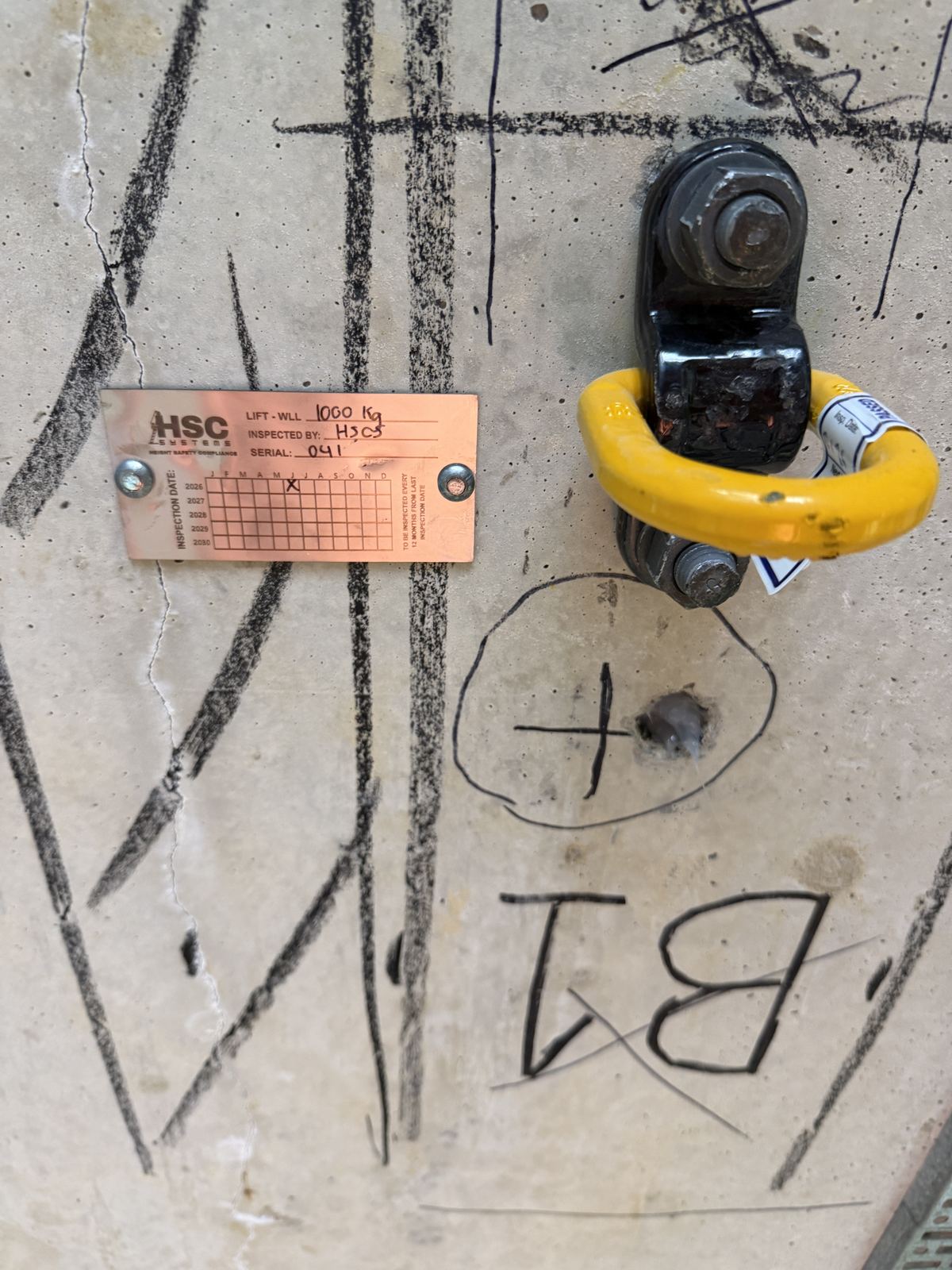 HSC Systems concrete mount anchor point tag showing lift working load limit and inspection dates