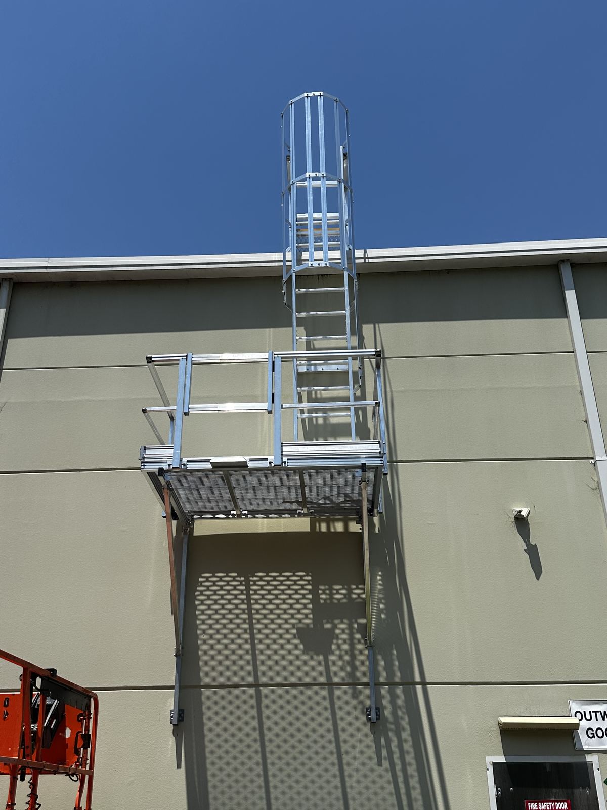 Aluminium caged rung ladder providing roof access